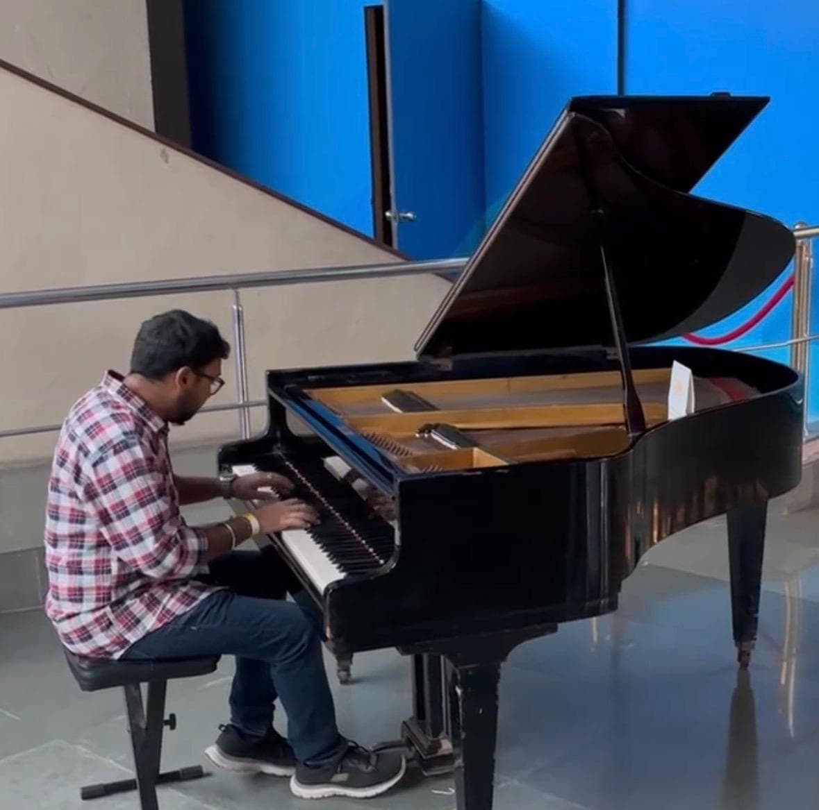 A grand piano on a dimly lit stage